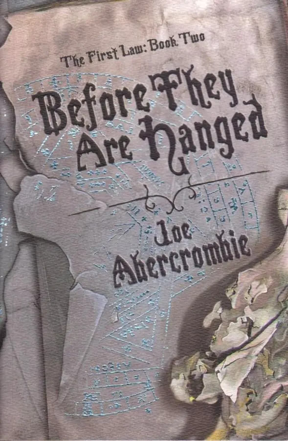 The Gollancz cover of Before They Are Hanged: an aged grey parchment marked with pale blue geometric diagrams and star charts, the title and Joe Abercrombie's name in gothic blackletter, with the line the first law: book two above.