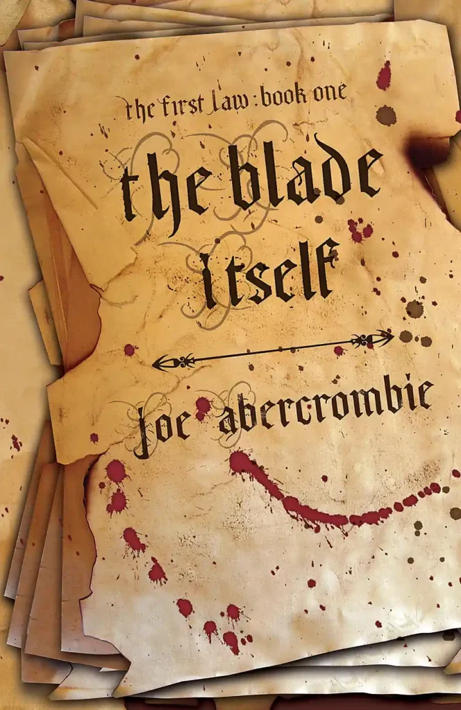 The Gollancz cover of The Blade Itself: a stack of aged, blood-spattered parchment pages with the title and Joe Abercrombie's name in gothic blackletter script, above the line the first law: book one.