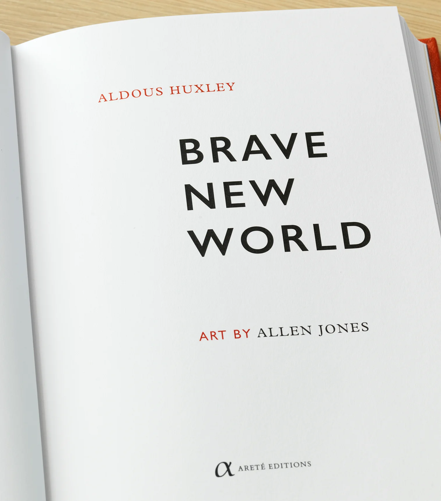 The title page of the Areté Editions Brave New World, letterpress printed on cream paper. Aldous Huxley's name appears in small red capitals at the top, the title in large black capitals across three lines, and the line Art by Allen Jones below it, with the Areté Editions colophon at the foot of the page.