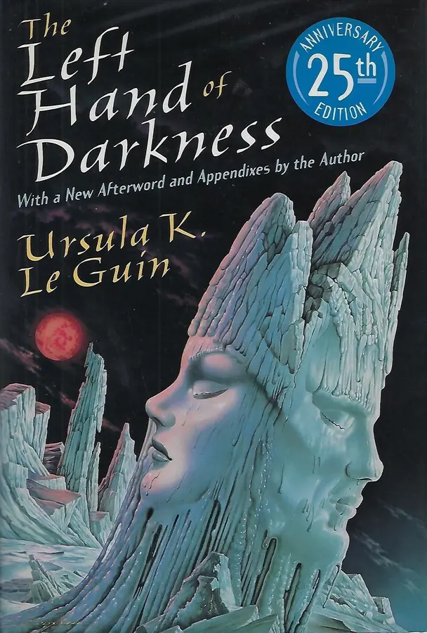 Cover of Ursula K. Le Guin's The Left Hand of Darkness, 25th Anniversary Edition, showing two faces carved from melting blue ice rising out of a glacial landscape under a black sky with a red moon.